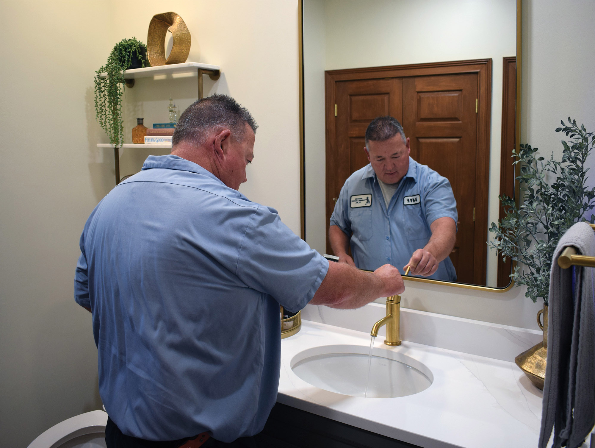 North Side Plumbing technician repairing a bathroom sink faucet